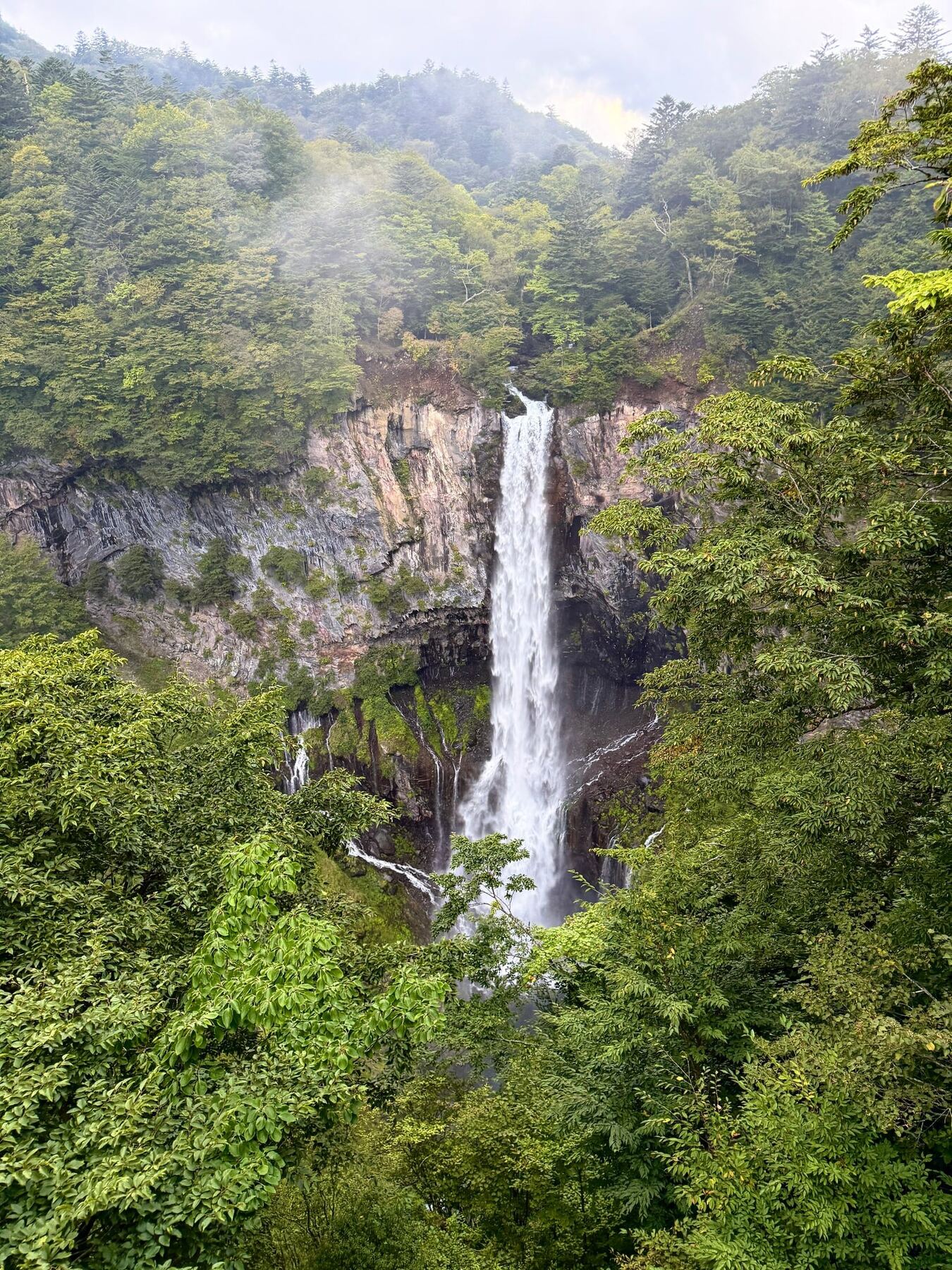 Kegon Falls descending through a forested mountainside in Nikkō