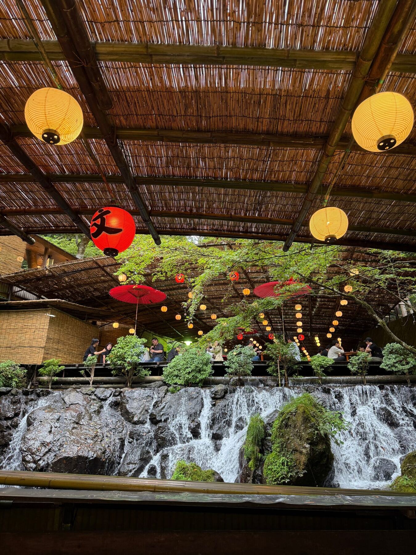 Lanterns, red parasols, and riverside dining terraces in Kyoto